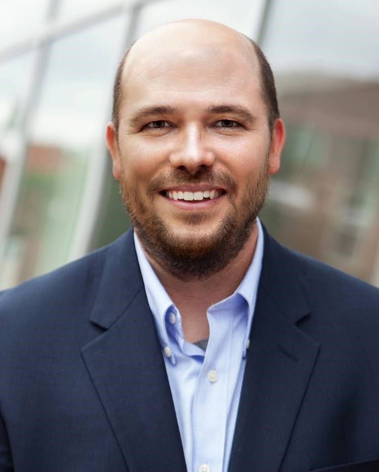 A man wearing a navy-blue suit