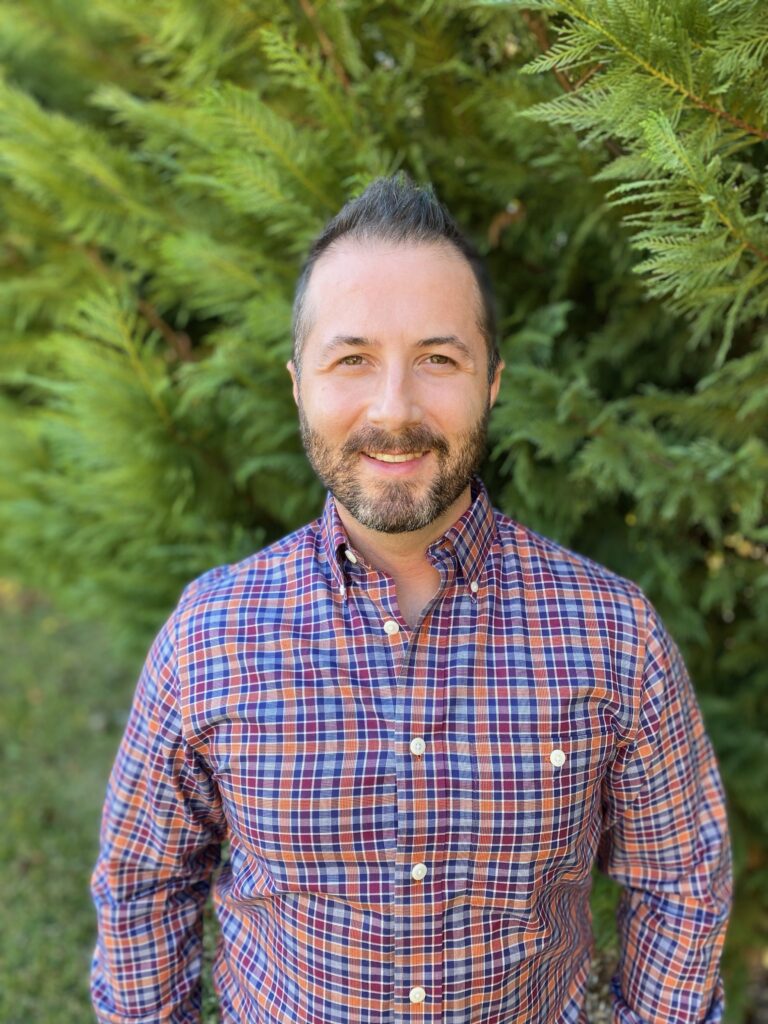 A man wearing a checkered polo